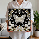 Person holding a decorative panel with a butterfly design in a living room setting