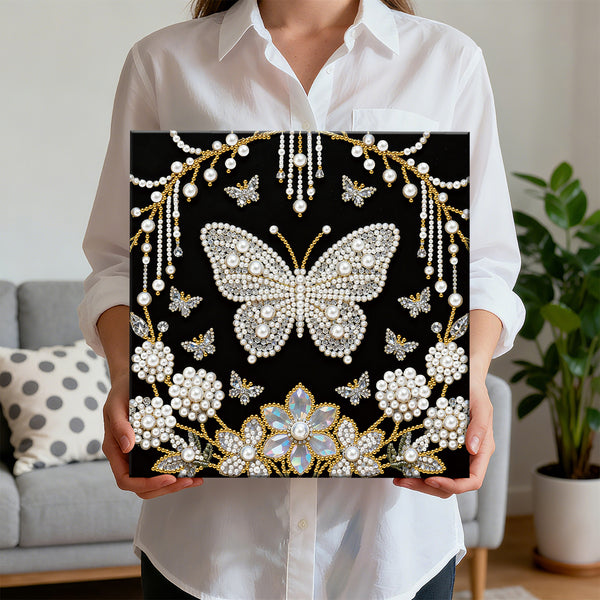 Person holding a decorative panel with a butterfly design in a living room setting