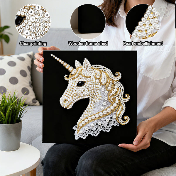 Person holding a decorative unicorn artwork with pearl embellishments, surrounded by a living room setting.