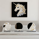 Decorative unicorn wall art with pearl embellishments on a gray wall.