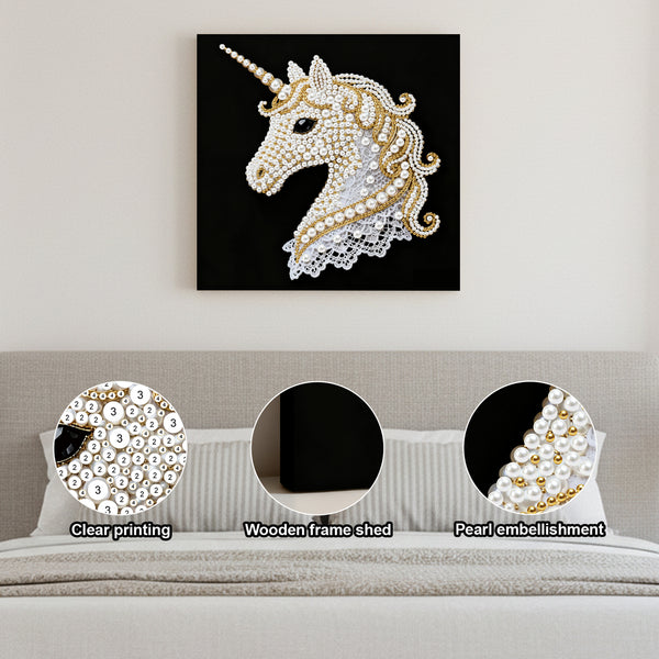 Decorative unicorn wall art with pearl embellishments on a gray wall.