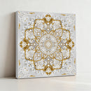 Decorative wall art with gold and white floral pattern on a gray background