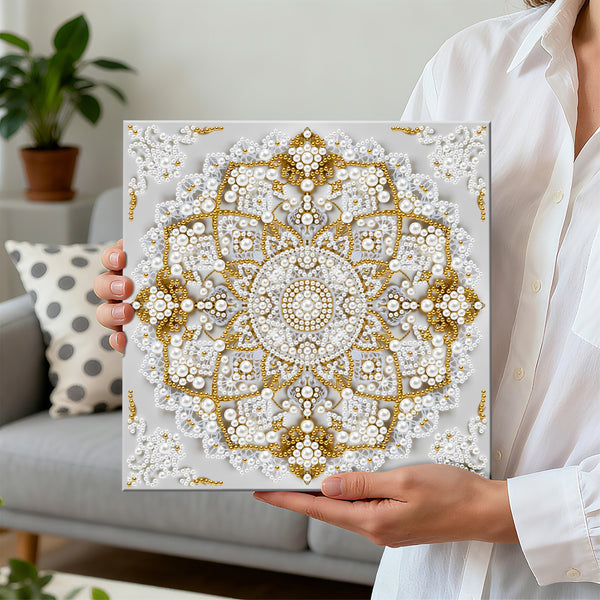 Person holding a decorative wall art piece with a mandala design featuring pearls and gold accents.