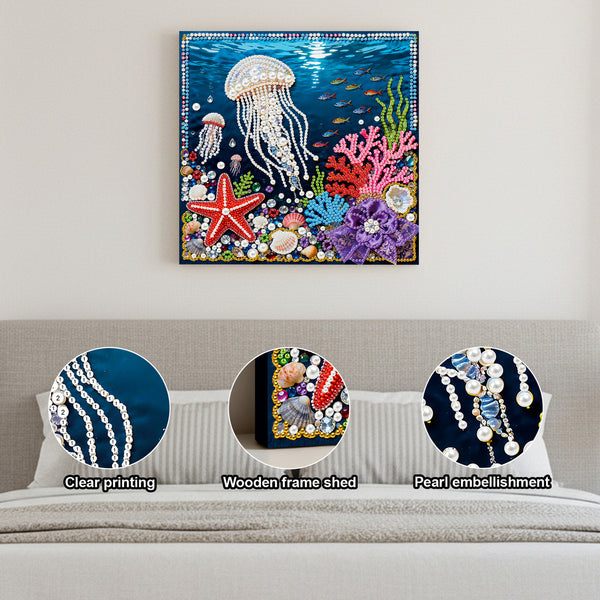 Decorative wall art of an underwater scene with a jellyfish, starfish, and coral on a plain wall.