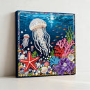Decorative wall art with beadwork of an underwater scene featuring jellyfish, starfish, and coral.