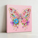 Decorative butterfly wall art with beads and flowers on a pink background