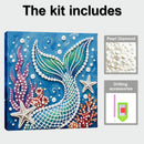 Mermaid tail diamond painting kit with pearl diamonds and drilling accessories on a blue background.
