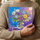 Person holding a completed DIY decorative pearl painting of flowers.