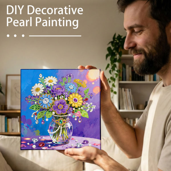 Man holding a completed DIY decorative pearl painting of a floral arrangement.