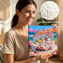 Woman holding a craft kit with a colorful design of an open shell filled with pearls, surrounded by pearls of different sizes.
