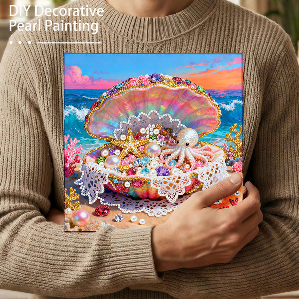 Person holding a completed DIY decorative pearl painting with a colorful shell and octopus design.