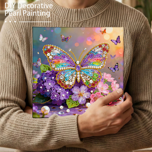 Person holding a colorful butterfly and flower painting with decorative pearls.