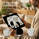 Person holding a DIY decorative pearl painting of an elephant in a living room.