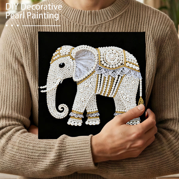 Person holding a completed DIY decorative pearl painting of an elephant.