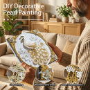 Person holding a DIY decorative pearl painting with peacock design in a living room setting.