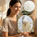 Woman holding a diamond painting kit with peacock design, showing close-up of pearls.