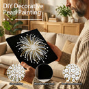 Person holding a DIY decorative pearl painting kit with pearl embellishments in a living room setting.
