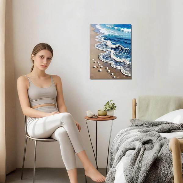Woman sitting on a chair in a bedroom with a beach scene painting on the wall.