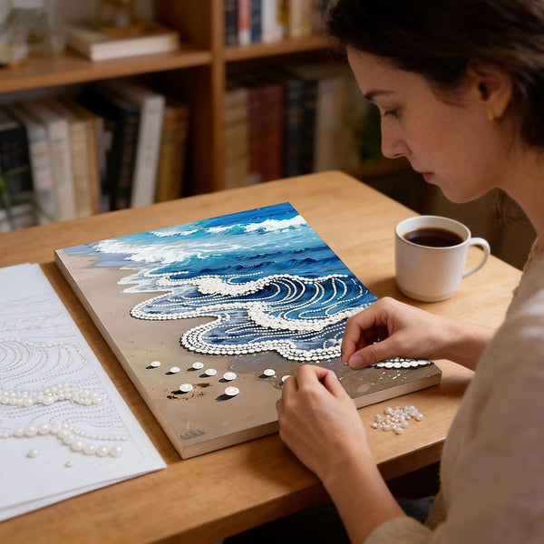 Woman working on a mosaic art project with a cup of coffee on a wooden table.