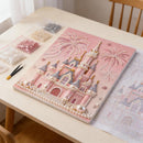 Pink castle design with beads on a table