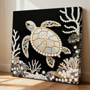 Decorative wall art of a turtle with pearl embellishments on a black background