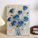 Decorative wall art with blue roses and pearls on a beige background