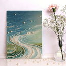 Decorative wall art with pearls and a vase with flowers on a white surface.