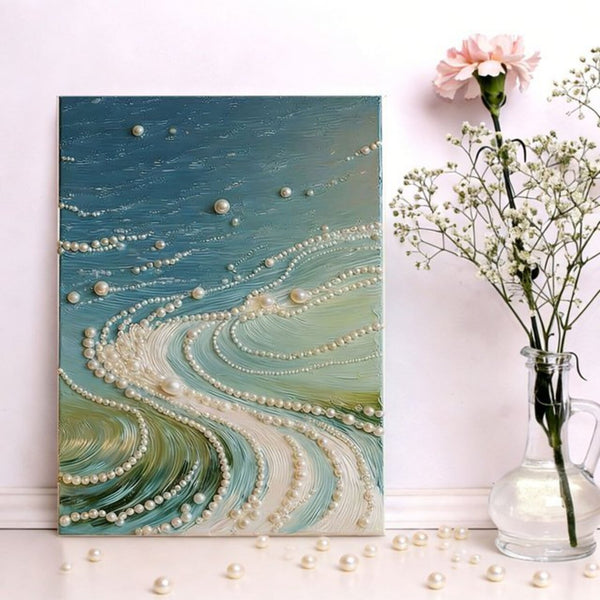 Decorative wall art with pearls and a vase with flowers on a white surface.