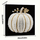 Decorative pumpkin with pearls and gold accents on a black background, with measurements indicated.