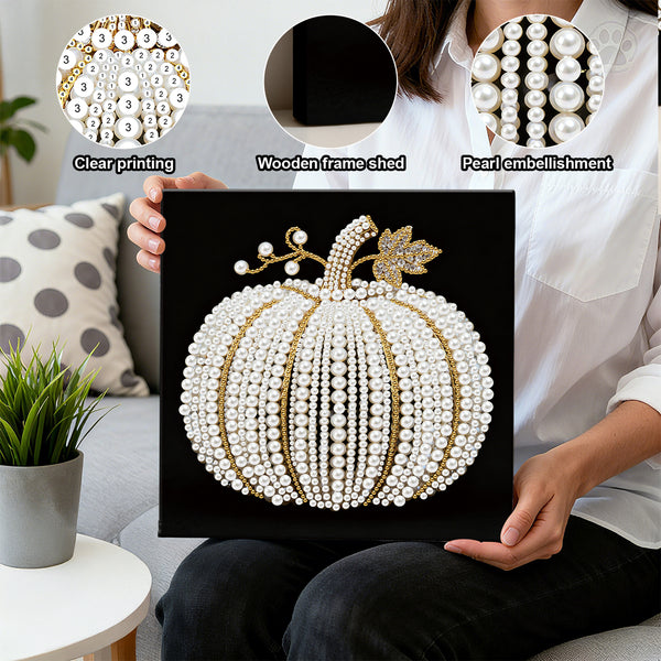 Person holding a decorative pumpkin art piece with pearl embellishments in a living room setting.