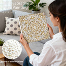 Woman holding a decorative pillow with pearl embellishments, surrounded by pearls of different sizes.