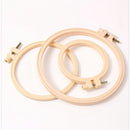 Two wooden embroidery hoops on a white background