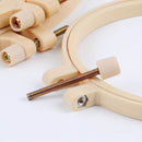 Wooden embroidery hoop with a screw on a white background