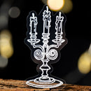 Decorative candelabra silhouette on a wooden surface with blurred lights in the background