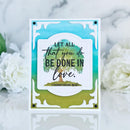 Card with 'Let all that you do be done in love' quote and tree design on a marble background with flowers.