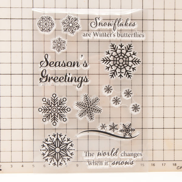 Set of snowflake stamps with text on a grid background