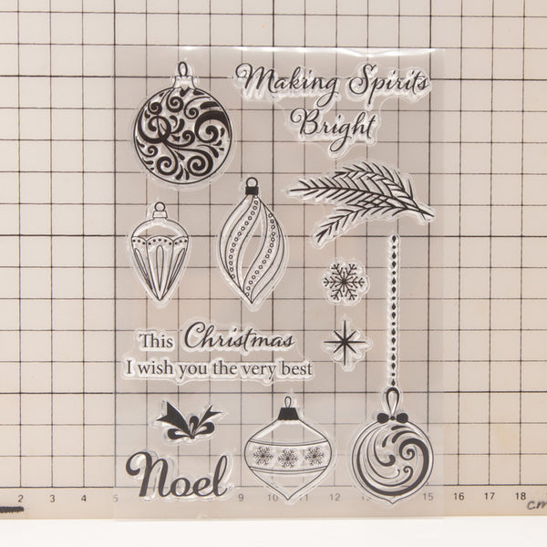 Clear stamps with Christmas designs and text on a grid background