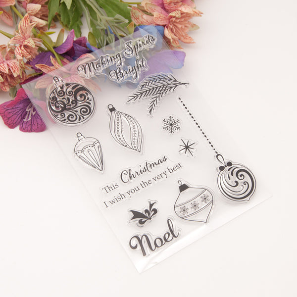 Clear stamp set with Christmas-themed designs on a white background with flowers.