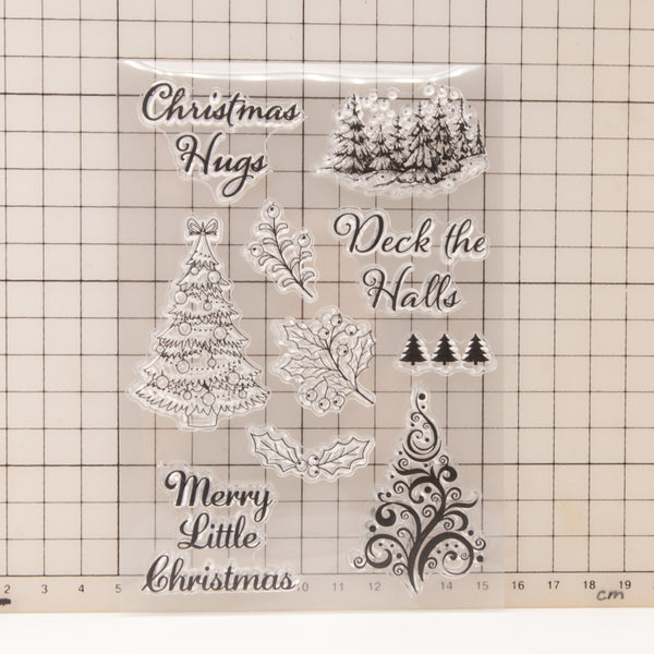 Clear stamp set with Christmas-themed designs and text on a grid background