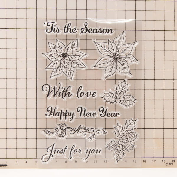 Clear stamp set with Christmas designs and text on a grid background