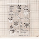 Decorative sheet with snowmen and snowflakes on a grid background