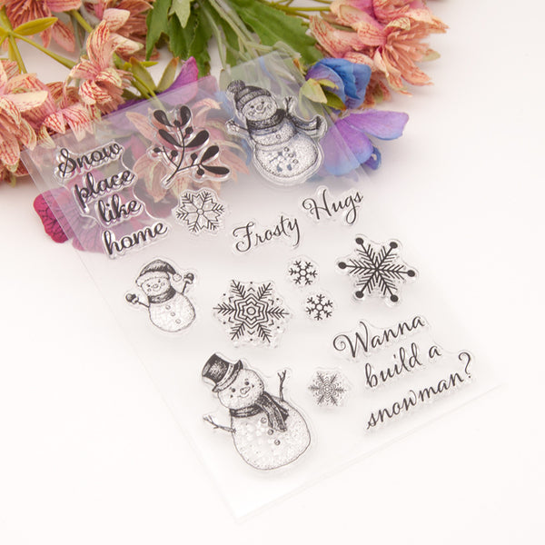 Clear stamps with winter-themed designs including snowmen and snowflakes on a white background.
