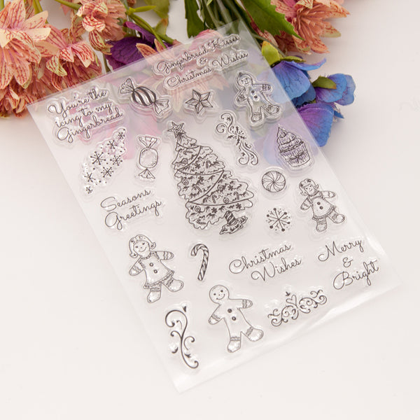 Clear stamp set with Christmas-themed designs on a white background with flowers.