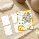 Decorative card with floral design and bees on a beige surface with feathers and pumpkins.