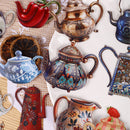 A collection of decorative ceramic teapots and pitchers with intricate hand-painted floral and geometric patterns, arranged on a white plate over a beige woven textile background.