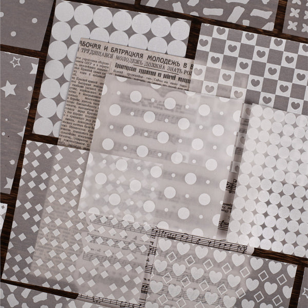 Collection of patterned paper sheets with different designs on a textured surface.