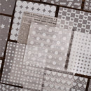 Collection of patterned paper sheets with different designs on a textured surface.