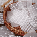 Wicker basket with patterned gray paper sheets on a wooden surface