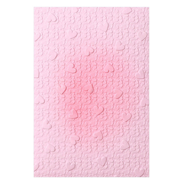 Pink textured paper with a subtle pattern on a white background