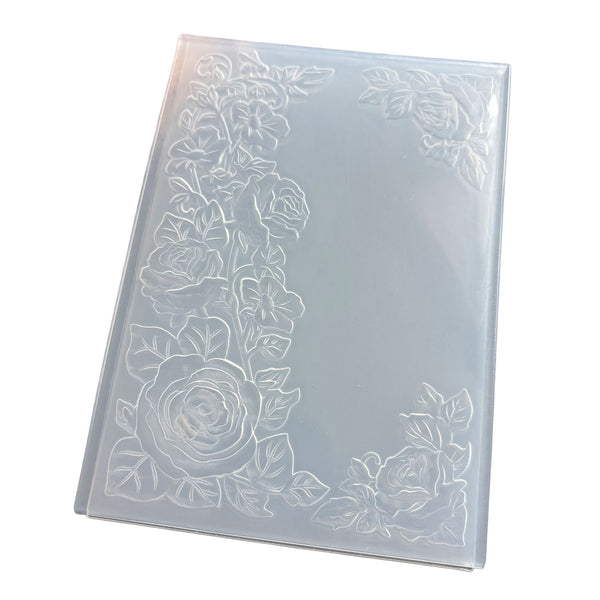 A rectangular translucent plastic sheet with embossed floral rose patterns along the borders, shown on a plain white background.